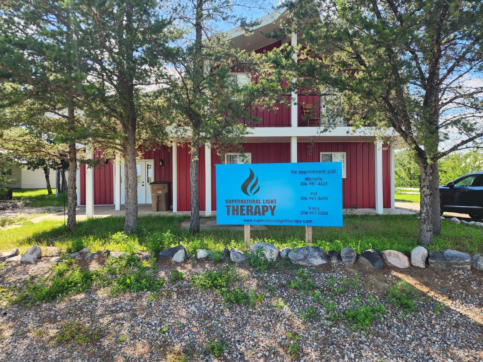 Supernatural Light Therapy building and sign in a quiet outdoor setting